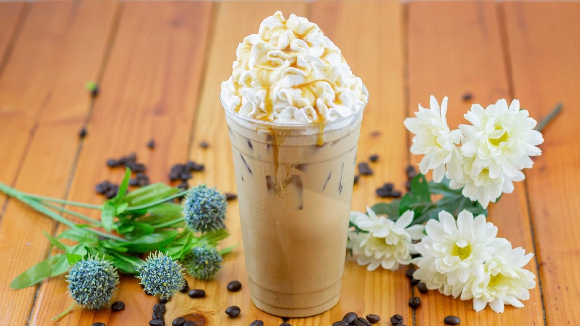 Iced caramel drink topped with whipped cream and caramel drizzle at Evergreen Coffee